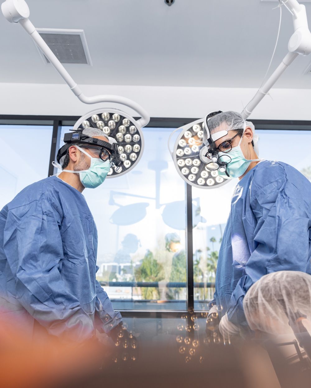 facial plastic surgeons in operating gear in the OR