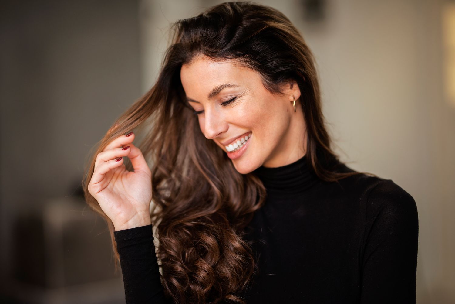 Woman smiling in a dental clinic setting.