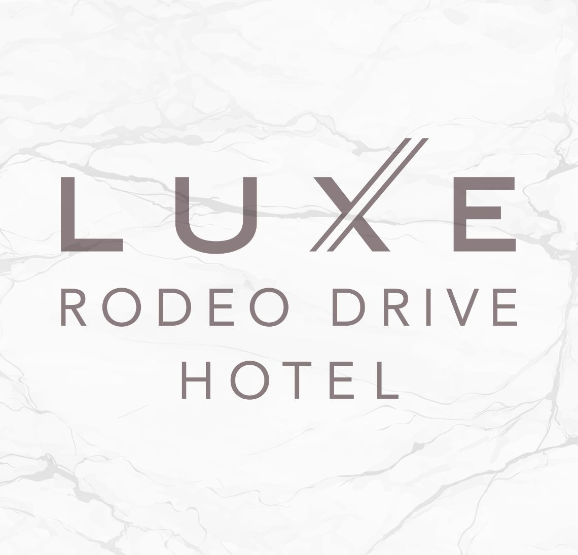 Luxe Rodeo Drive hotel logo on marble background