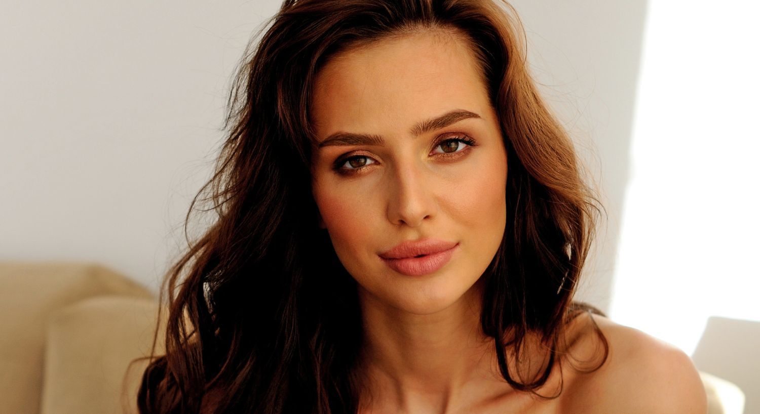 Portrait of a woman with wavy brown hair.