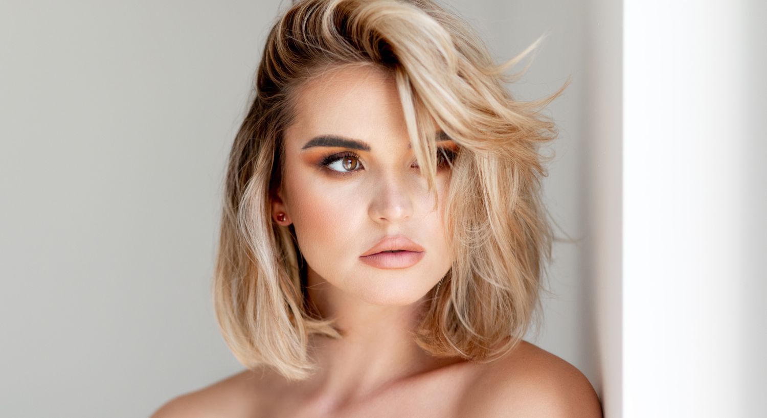 Portrait of a woman with tousled blonde hair.